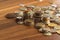 Different gold and silver collector`s coins on the wooden table