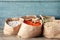 Different grains and cereals in paper bags on table