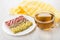 Different granola bars in white plate, napkin and tea