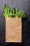 Different green healthy food in recycling paper bag