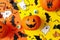 Different halloween accessories and pumpkins on two tone background