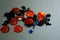 Different Halloween vivid decorations. Orange smiling pumpkins, blue and silver stars. Black witches and bats