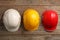 Different hard hats on wooden background, top view.