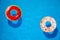 Different inflatable rings floating in swimming pool