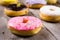 Different kinde of round donuts on wooden table. Closeup