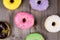 Different kinde of round donuts on wooden table. Top view