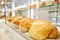 Different kinds of bread on the counter in the bakery shop. Fresh bread counter. Modern bakery with different kinds of