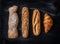 Different kinds of bread rolls on black from above