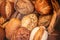 Different kinds of Freshly Baked  Bread, may use as background, top view.  Rustic loaves of bread close up