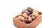 Different kinds of nuts in the shell: hazelnut, walnut, almond and brazil nuts in wooden box, isolated on a white background