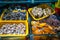 Different kinds of raw fresh seafood in water tanks at an asian seafood market in Sanya, Hainan, China