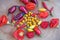 Different kinds of red and yellow hot chilly peppers on wooden plate