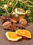 Different kinds of spices, nuts, cone and dried oranges, Christmas decorations and spruse branch