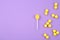 Different lemon candies on purple background, top view. Space for text
