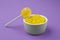 Different lemon flavored candies on purple background