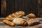 Different loaves of bread cooked with flour and gluten-free wheat on a wooden table