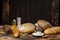 Different loaves of bread cooked with flour and gluten-free wheat on a wooden table