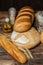 Different loaves of bread cooked with flour and gluten-free wheat on a wooden table