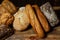 Different loaves of bread cooked with flour and gluten-free wheat on a wooden table