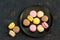 Different macaroon on black plate