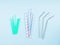 Different material drinking straws on pastel blue