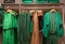 different models green and dresses blouses in the store grouped in the color