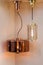 Different modern streamlined mirror copper chandeliers. Cylindrical metal copper shade pendant