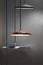 Different modern streamlined mirror copper chandeliers. Metal copper disk shaped pendant lamps. Loft style