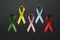 Different multi colored awareness ribbons on black background