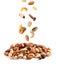 Different nuts falling into pile on background