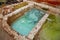 Different old stone vats with blue and yellow dye for leather at Tannery of Tetouan Medina.