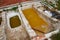 Different old stone vats with dye for leather at Tannery of Tetouan Medina.