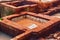 Different old stone vats with red dye for leather at Tannery of Tetouan Medina. Northern Morocco