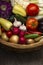 Different Organic Fruits and vegetables in basket on wooden table back