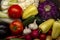 Different Organic Fruits and vegetables on wooden table back. Food background with assortment