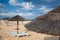 Different parasols and sun loungers on the empty beach on Tavira island, Algarve. Portugal