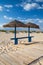 Different parasols and sun loungers on the empty beach on Tavira island, Algarve. Portugal