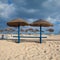 Different parasols and sun loungers on the empty beach on Tavira island, Algarve. Portugal