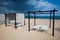 Different parasols and sun loungers on the empty beach on Tavira island before storm, Algarve. Portugal