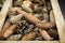 Different pine fir tree cones in vintage wooden garden box at Christmas market. Natural decoration materials for holiday crafts