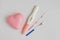 Different positive pregnancy tests with a pink heart