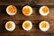 Different readiness stages of boiled chicken eggs on table, flat lay