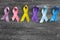 Different ribbons on wooden background. Cancer awareness concept