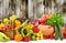 Different ripe fruits and vegetables on dark wooden background for kitchen panel