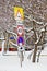 Different road signs under the snow near the building