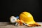 Different safety equipment on wooden table against black background