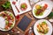 Different salads on wooden table, top view.