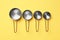Different saucepans on yellow background, flat lay. Cooking utensils