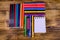 Different school stationeries pens, notepad, pencils, felt tip pens and ruler on a wooden background. Top view