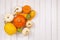 Different seasonal pumpkins and squashes on side of white wooden background